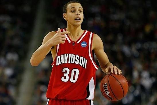 Curry dribbling in a red Davidson No. 30 jersey