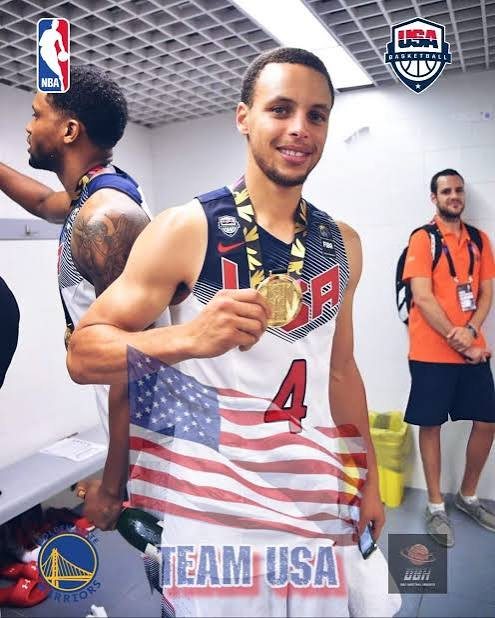 Curry in a Team USA No. 4 jersey showing his gold medal
