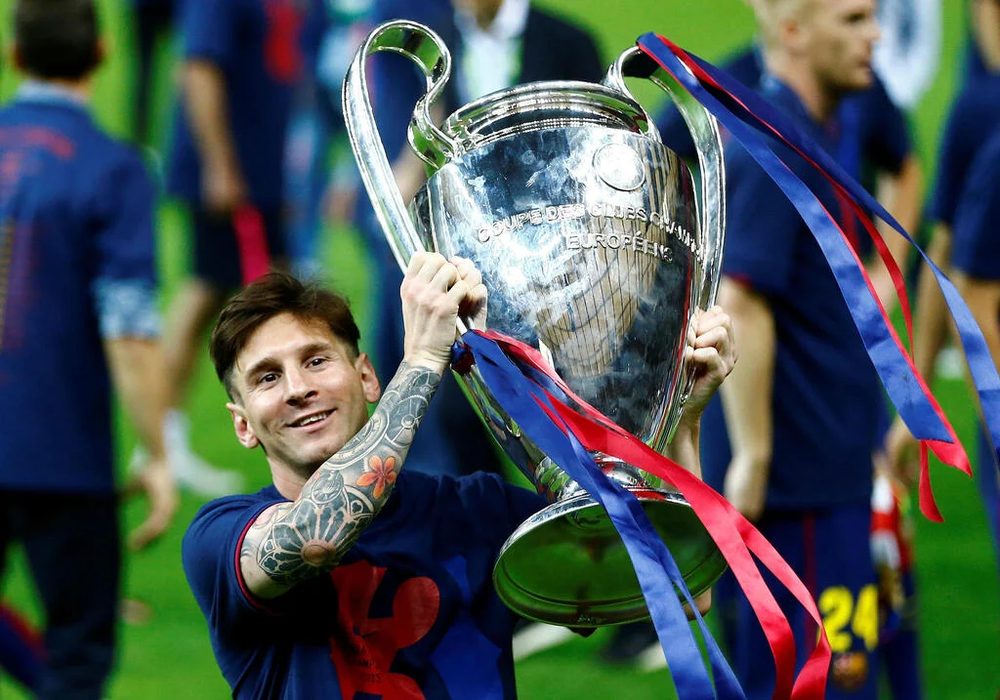 Messi lifting the Champions League trophy with Barcelona