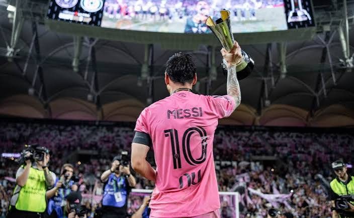 Messi in Inter Miami pink raising a trophy
