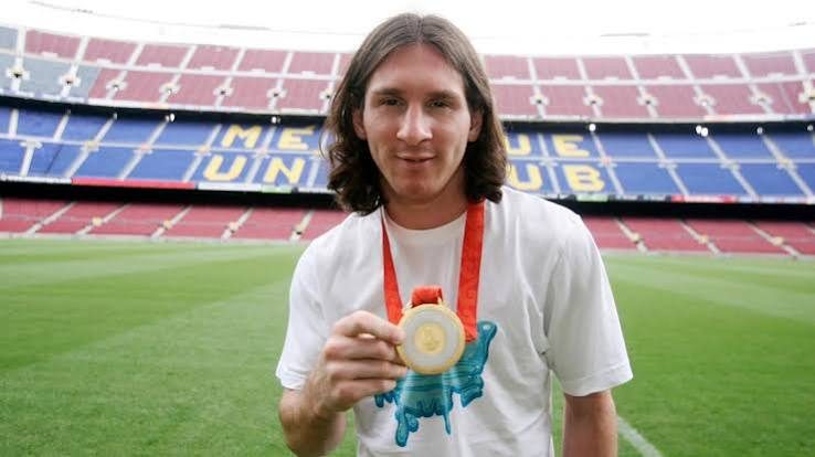Messi showing his Olympic gold medal at Camp Nou